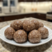 No-bake protein energy balls on a white plate, made with oats, peanut butter, and chia seeds